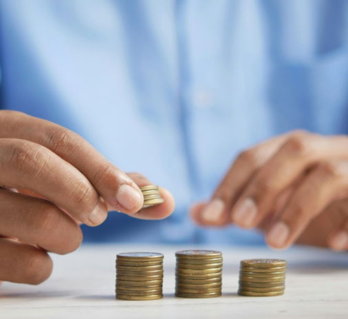 a person stacking coins on top of a table